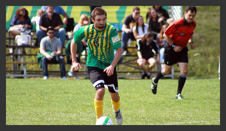 lee dennis dribbles the ball