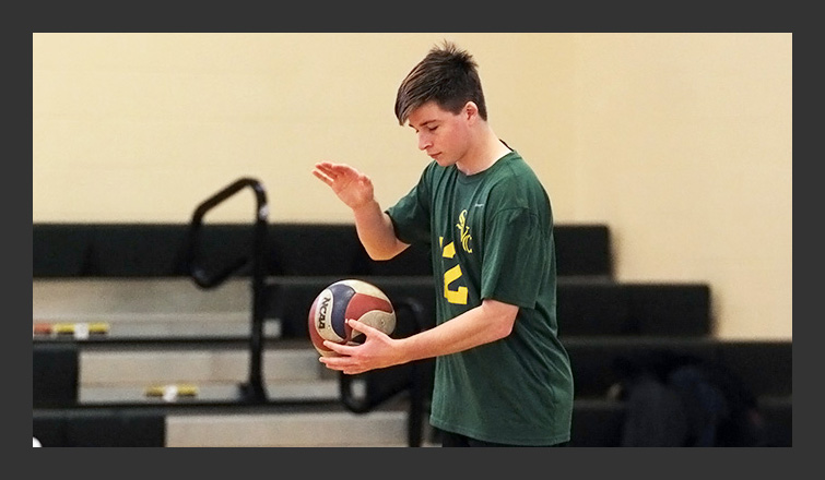 jesse kelley gets ready to bounce the ball before a serve