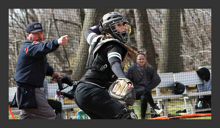 nicole matthews makes a throw from behind the plate