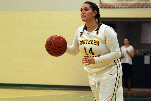 Amber Dow dribbles the ball up the court.