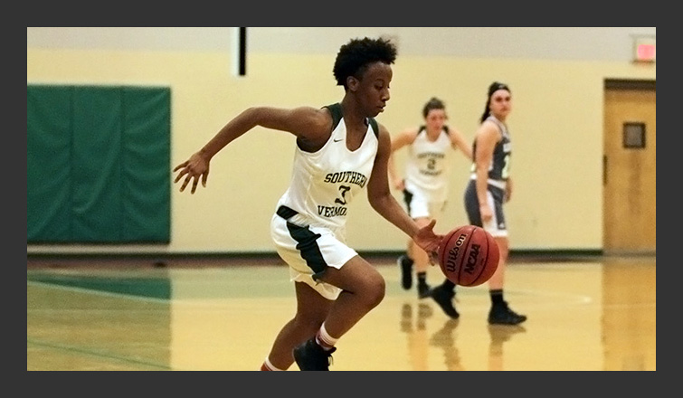 ahmyria simmons dribbles the ball up the court