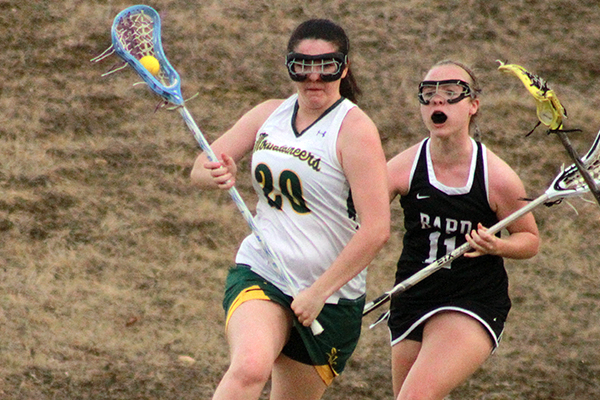madi carr speeds past a defender
